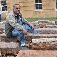 Artist-in-residence at USAO, Jesus Moroles, with granite blocks being used in the construction of Coming Together Park on the campus in Chickasha.  mh
