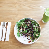 The Ironman salad contains arugula, black lentils, roasted beets, red onion, basil, tahini and balsamic glaze and a smoothie.