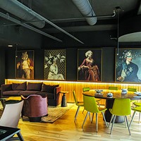 Artwork overlooks the second story of Bar Cicchetti that blends dining and lounge areas.