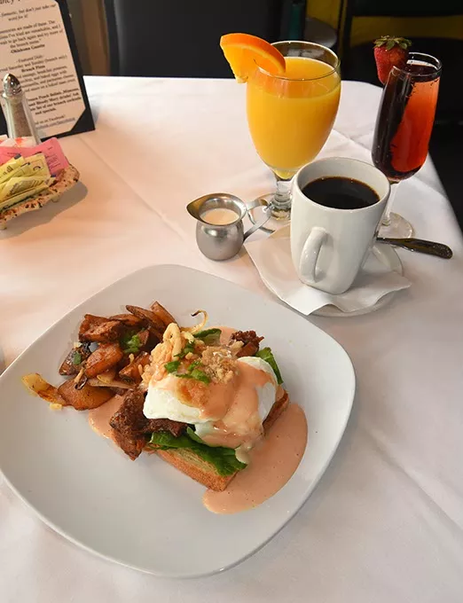 BBQ Brisket Benedict with coffee, orange juice, and Kir Royal (Creme de Cassis and Champagne), at Fancy That on Main Street in Norman. mh