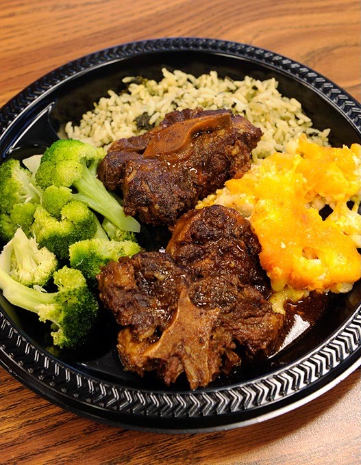Oxtail, spinach rice, broccoli, macaroni and cheese, at Carican Flavors in Oklahoma City, Thursday, Dec. 18, 2015. - GARETT FISBECK