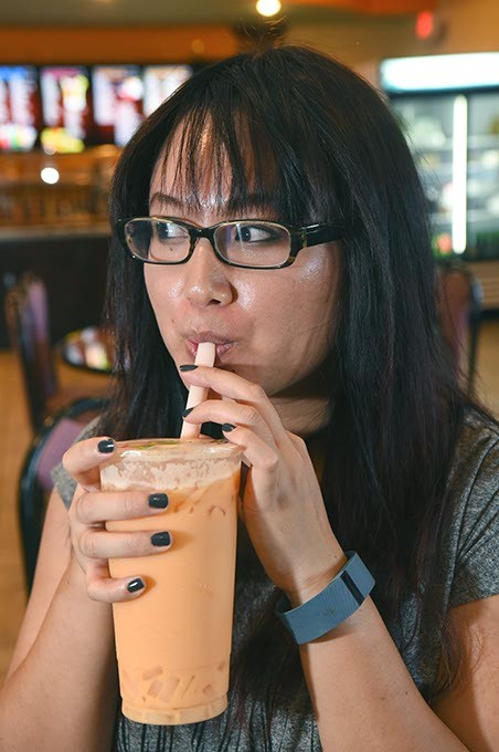 Michelle Bui enjoys a bubble tea while waiting for friends and food at Hy Palace.  mh