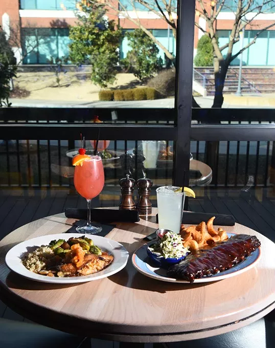 Stuffed Catfish with a KD's Breeze cocktail, left, next to Baby Back Ribs with a Loud City Lemonaid, next to the window overlooking the Bricktown Canal at KD's in Lower Bricktown, Oklahoma City, 1-25-16. - MARK HANCOCK