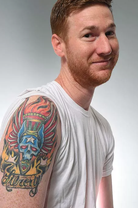Comedian Spencer Hicks with his misspelled (then “fixed”) tattoo. (Mark Hancock)