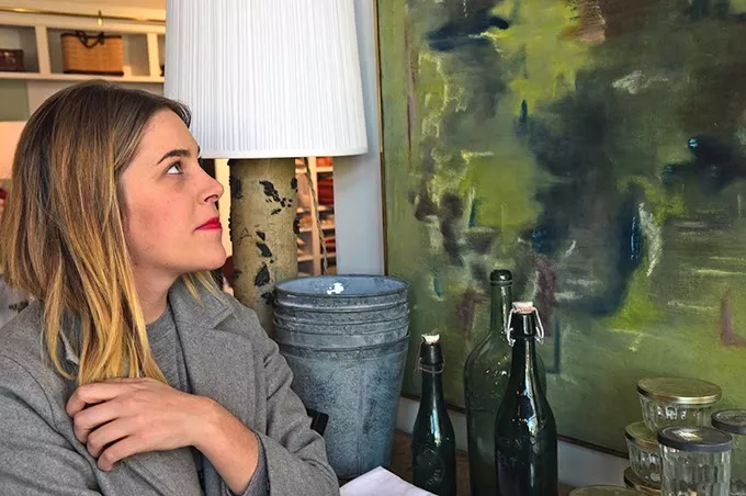 Sara Kate Huff, owner of Sara Kate Studios in Automobile Alley, with artwork and other home decor items at the new shop. mh