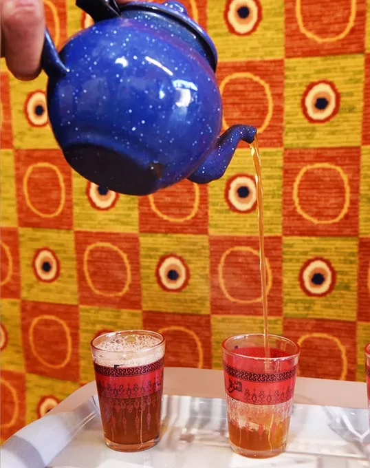 Pouring glasses of Moroccan hot mint tea at Argan Cafe, 2908 NW 23rd Street, OKC, 12-10-15. - MARK HANCOCK