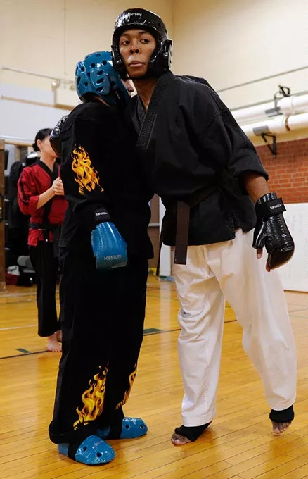 Nieko Ligons, 17, hugs Sierra Carter, 16, after sparring at Harding Fine Arts Academy in Oklahoma City, Wednesday, Jan. 21, 2015. - GARETT FISBECK