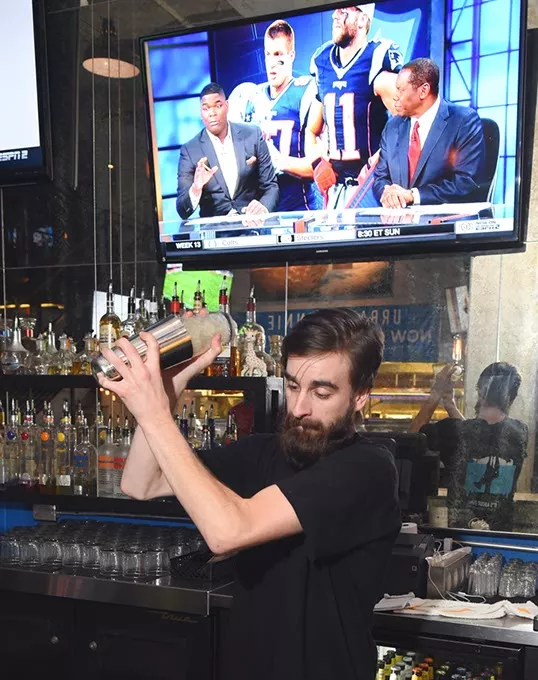 The bar tender ( I have his name) mixes a drink at Urban Jonnie Bar & Grill in Oklahoma City, 11-30-15. - MARK HANCOCK