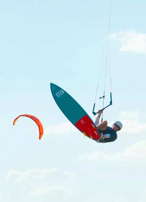 Expert kite boarder Daniel Nicholson flying high over Lake Hefner. - SHANNON CORNMAN