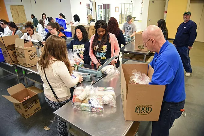 Volunteers from South Moore High School work with donations in the Volunteer Center at Regional Food Bank of Oklahoma. mh