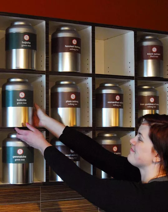 Kasey Best reaches for a canister of tea at t, an Urban Tea House. file photo mh