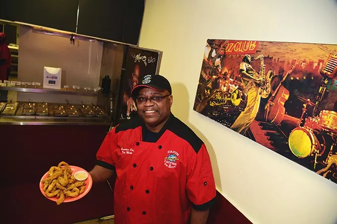 C'est Si Bon owner, Ken Mills, with a plate of fresh fried catfish. mh