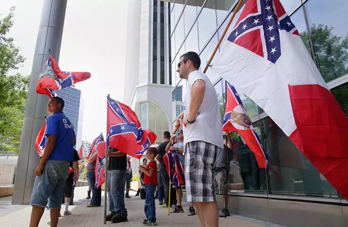 Confederate flag supporters gather in the shade of Tulsa’s City Hall as they hold a rally to support the flag, July 25, 2015. (Photo Michael Wyke / Tulsa World / File / Provided)