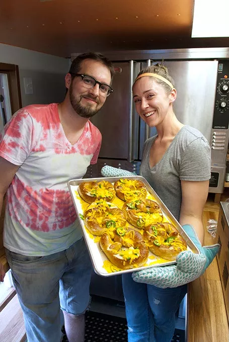 Lance and Becky King with fresh pretzels inside their Twist Gourmet Pretzel Truck which they just parked for Live on the Plaza, 7-11-14.