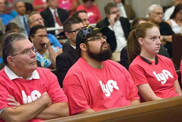 Lyft drivers including James Keenean, center, pay attention during OKC Council meeting proceedings, 8-26-14. mh