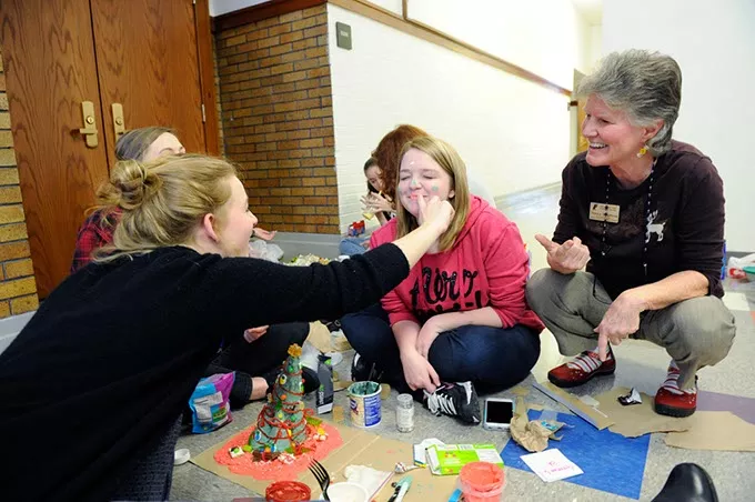 Lena Koehler puts frosting on Natalie Trujillo's face as Nancy Boudreau looks on at Classen SAS in Oklahoma City, Wednesday, Dec. 9, 2015. - GARETT FISBECK