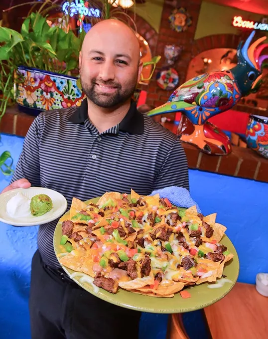Abel Delpera with the El Mexicano Nachos at San Marcos Mexican Restaurant, 2301 SW 59th Street, 9-8-15. - MARK HANCOCK