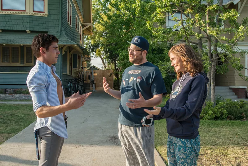 Teddy Sanders (ZAC EFRON) has a chat with neighbors Mac (SETH ROGEN) and Kelly Radner (ROSE BYRNE) in "Neighbors", a comedy about a young couple suffering from arrested development who are forced to live next to a fraternity house after the birth of their newborn baby. - PHOTO CREDIT: GLEN WILSON