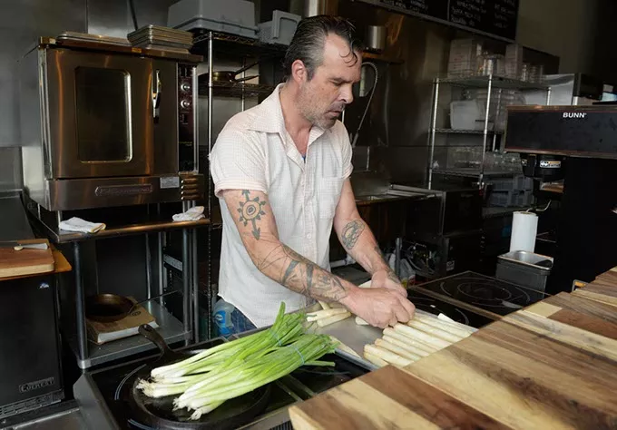 Bryce Lack preps for the week at Derailleur in Yukon, Tuesday, Aug. 23, 2016. - GARETT FISBECK