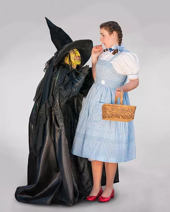 Renee Anderson as the Wicked Witch of the West and Arden Walker as Dorothy. Photo by KO Rinearson - KO RINEARSON