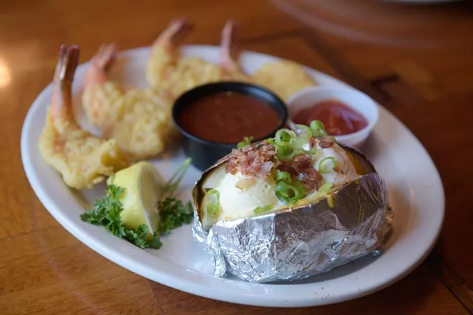 Bear-battered shrimp with baked potato at Pelican's in Midwest City, Tuesday, July 18, 2017. - GARETT FISBECK