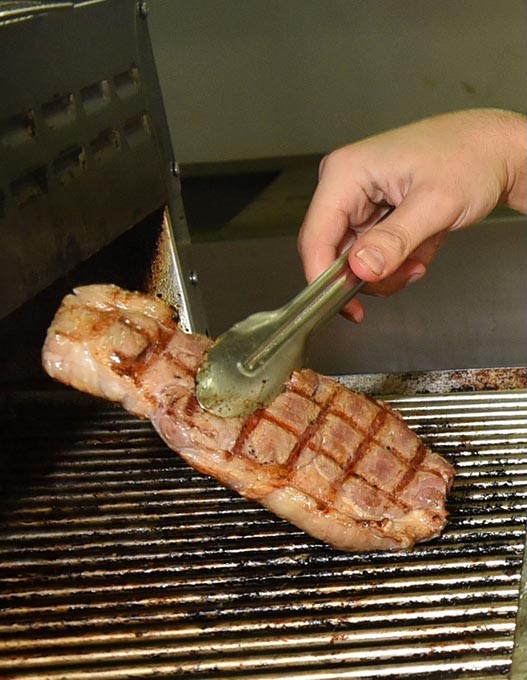 A New York Strip steak hot off the grill is ready for delivery, at Oklahoma Steak and Grill Delivery in Edmond, 10-29-15. - MARK HANCOCK