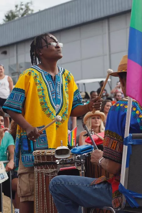 A participant in the parade plays a variety of percussion instruments on a float during Pride on Sunday, June 25, 2017. (Cara Johnson).
