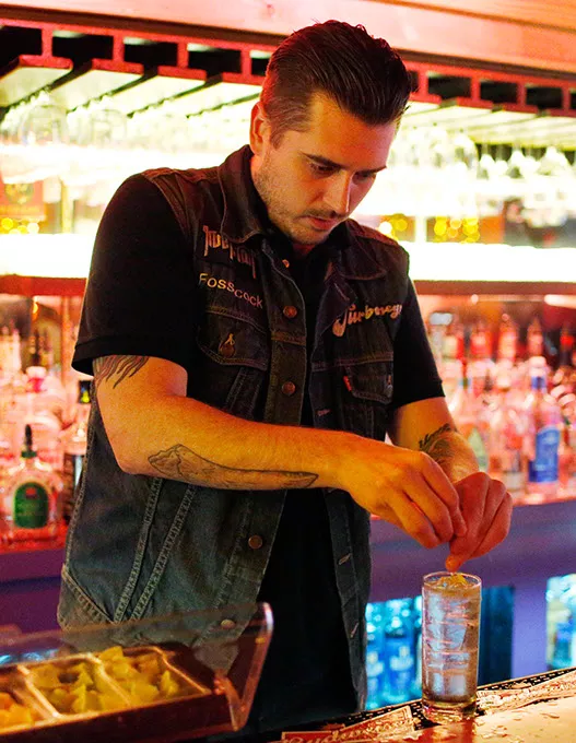 Ian Taylor makes a drink at the Hilo Club in Oklahoma City, Friday, Nov. 6, 2015. - GARETT FISBECK