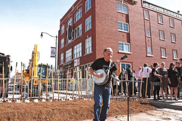 Johnny Baier strums the banjo as the crowd gathers for the groundbreaking of the MAPS 3 modern streetcar in Bricktown. | Photo Laura Eastes