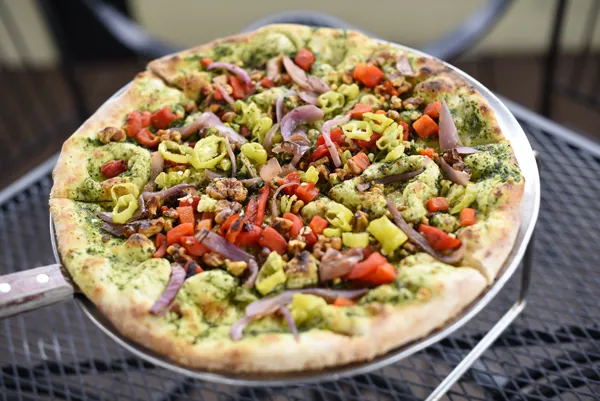 The Wedge Pizzeria’s The Brandon, with pesto, roasted red onion and red bell pepper, pepperoncinis and spiced walnuts | Photo Garett Fisbeck