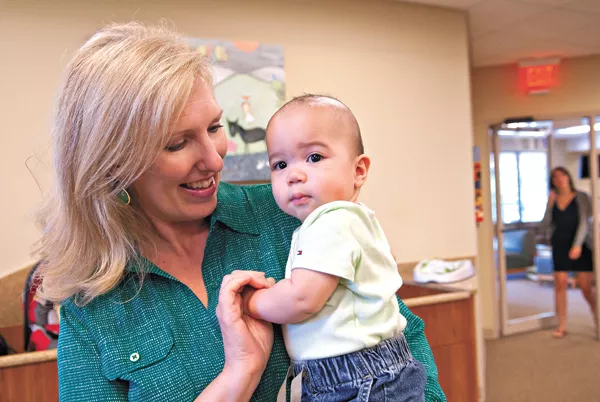 Jo Lynne Jones, Director of Development and Communications, with Nehemiah E. Ramirez at Infant Crisis Services, Inc. mh