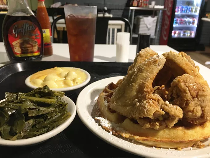 The chicken and waffle, featuring four huge wings, is the signature dish at Mama E’s. | Photo Jacob Threadgill