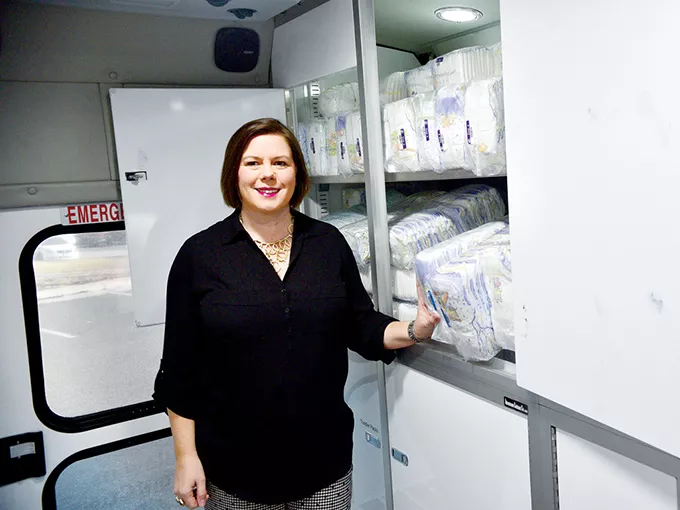 Jilian Larimore, executive director of Impact Oklahoma, stands inside one of Infant Crisis Services’ BabyMobiles. | Photo Laura Eastes