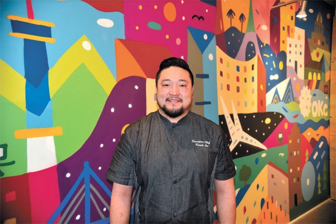Chef Kevin Lee stands in front of a mural by artist Kris Kanaly representing Lee&#146;s influences at Gogi Go. | Photo Jacob Threadgill