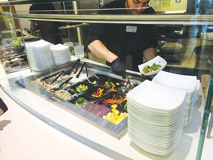 Guests choose which vegetables and protein - to pair with either rice or noodles at the Asian bowl station in Nebu. - JACOB THREADGILL
