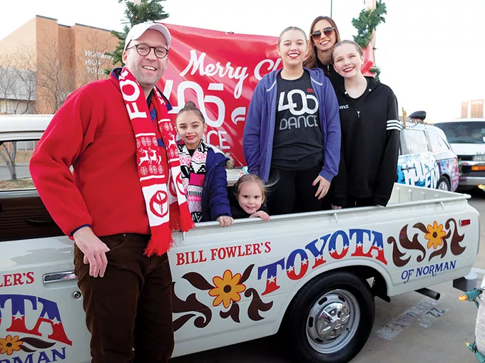 Jonathan Fowler poses with a restored 1973 Toyota pickup at the Norman Christmas Parade. The pickup was restored with the same body paint used on one that was driven in the parade in the 1970s. - FOWLER HOLDING COMPANY / PROVIDED