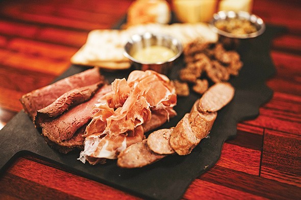 The meat-and-cheese plate features Oklahoma sausage, mustard and in-house brined and smoked pastrami. - ALEXA ACE