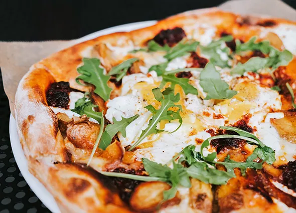 The breakfast pizza features local eggs, potatoes and nduja, a spreadable Italian sausage. - PROVIDED
