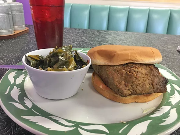A meatloaf sandwich with a side of collard greens - JACOB THREADGILL