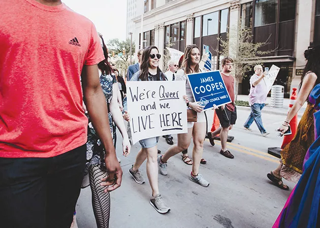 Community members walked behind James Cooper as they paid homage to a similar procession led by the late Harvey Milk, California’s first openly gay elected official. - ALEXA ACE