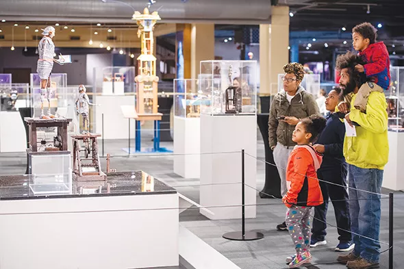 Guests examine Jim Casey’s “Ezra the Chronicler” and “Henry the Contemplative Robot” in Life Imagined: The Art and Science of Automata in Science Museum Oklahoma’s smART Space galleries. - PHOTO SCIENCE MUSEUM OKLAHOMA / PROVIDED