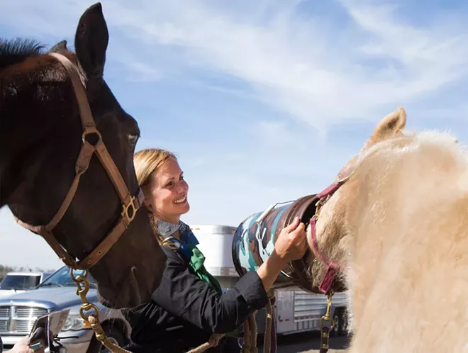 Lori Wilfcord-Herbenick, of Jacksonville, - waters her daughter’s horse Flicka after the drive.