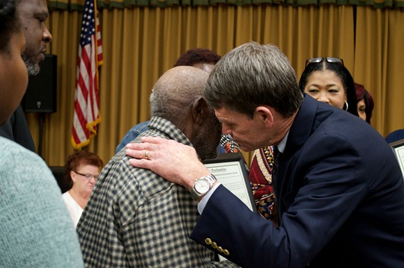 Groveland Mayor Tim Loucks hugs a relative of the Groveland Four. - PHOTO BY MONIVETTE CORDEIRO