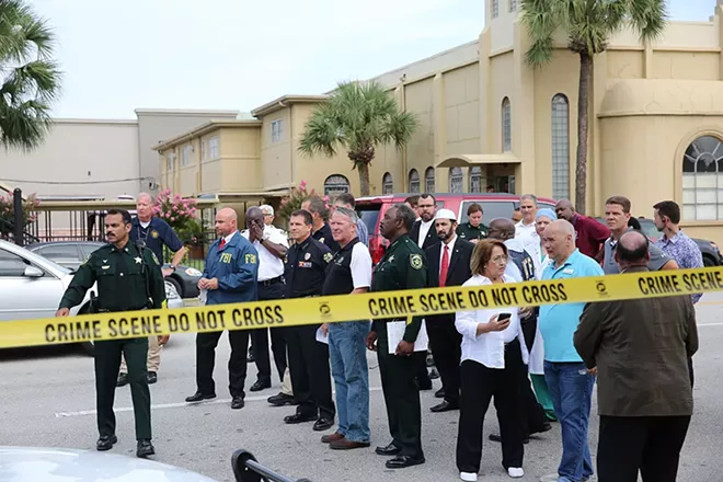 Federal, Orange County and Orlando city officials prepare to give statements to the media. - PHOTO BY JOEY ROULETTE