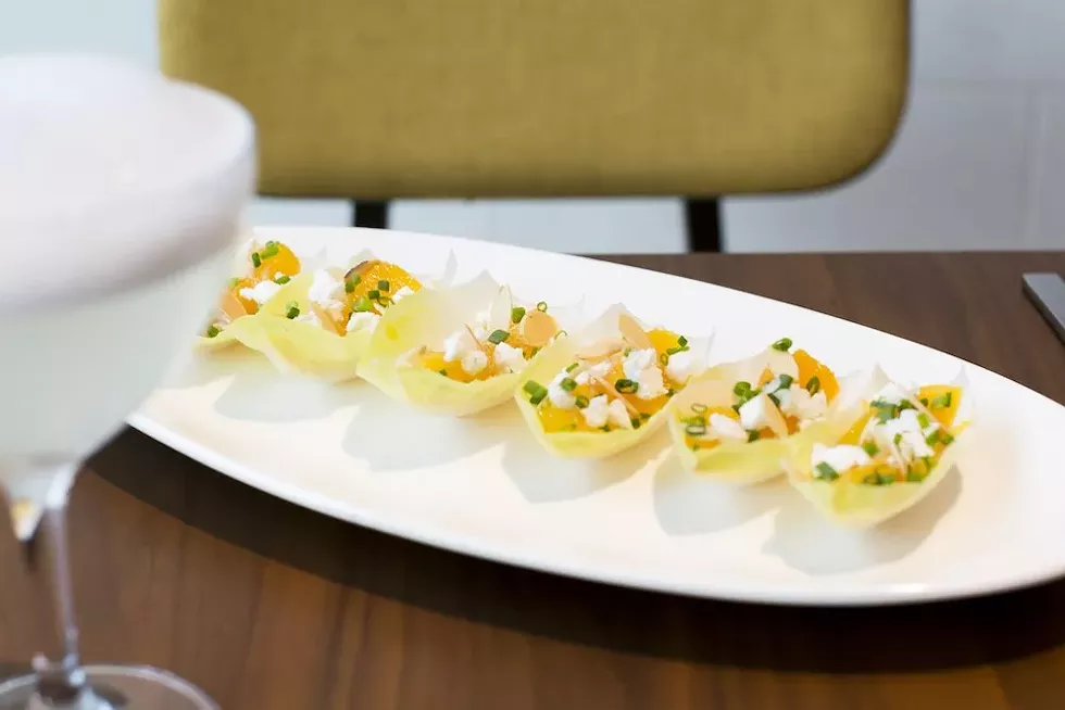 Jaleo's goat cheese endive, a dish that includes fresh oranges, almonds, goat cheese and a sherry dressing - PHOTO BY ROB BARTLETT