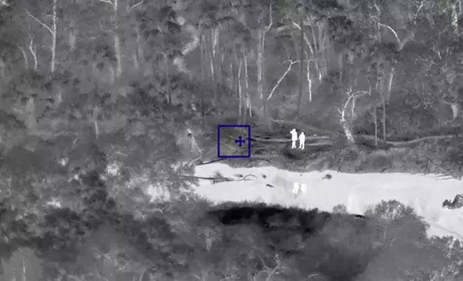 Two kayakers, whose inflatable boat was flipped over by an alligator on the Econlockhatchee River, wait to be rescued by the ALERT team at the Seminole County Sheriff's Office on Monday. - SEMINOLE COUNTY SHERIFF'S OFFICE VIA FACEBOOK