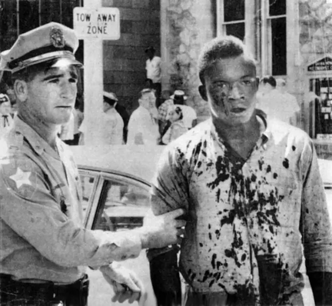 Charlie Griffin, a victim of the violence in Jacksonville on August 27, 1960, is detained by police. - PHOTO VIA FLORIDA STATE ARCHIVES