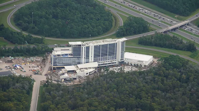 An aerial image from late 2019 showing the then still under construction JW Marriott Bonnet Creek Creek Resort & Spa with traffic on nearby I-4 seen in the upper corner of the image. - IMAGE VIA BIORECONSTRUCT | TWITTER