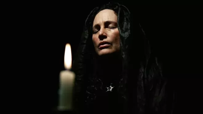 Ivy (Toby Poser) communes with the spirits in the haunting and heartbreaking ghost story "The Deeper You Dig" - ARROW VIDEO