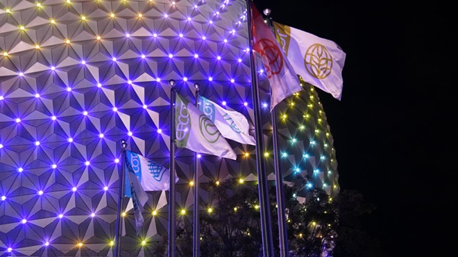 Spaceship Earth with its new LED lighting, seen here with the new Epcot entrance flags - IMAGE VIA BIORECONSTRUCT | TWITTER